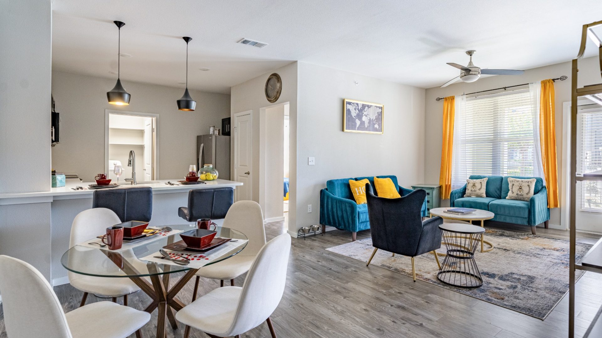 a living room and dining area with a blue couch at The Landmark at Crowley