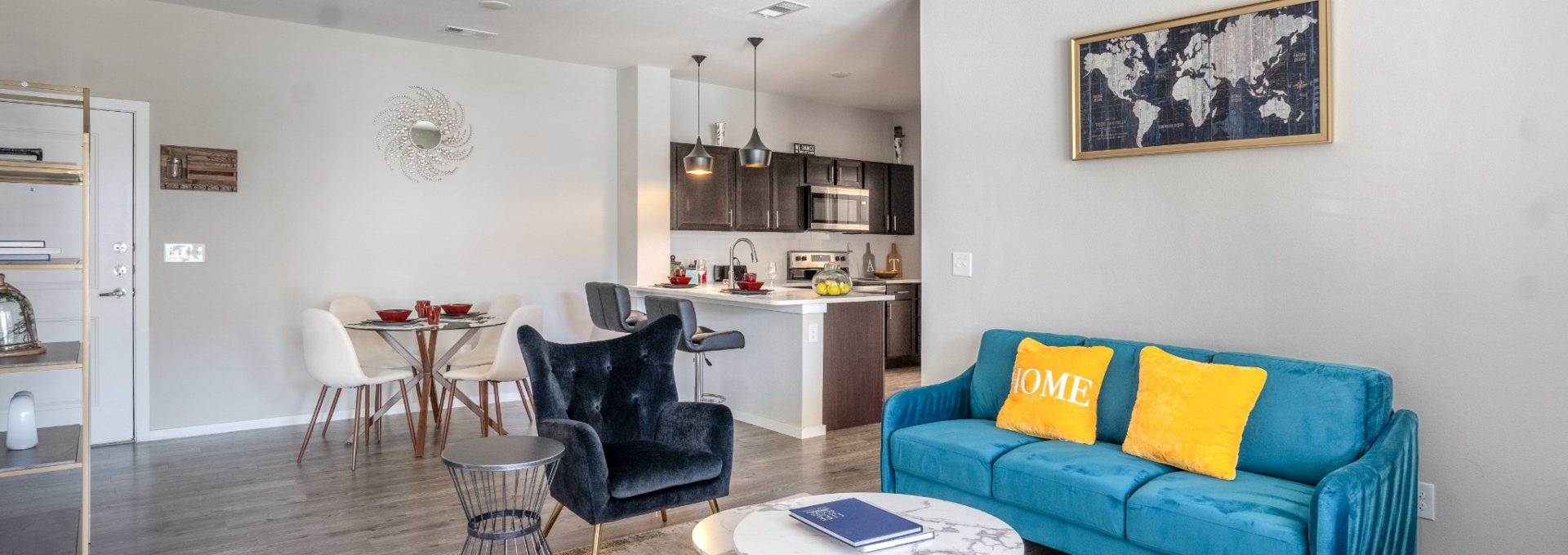 a living room with blue couches and a ceiling fan at The Landmark at Crowley